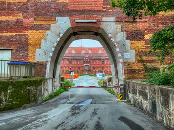 Arch bridge amidst buildings in city