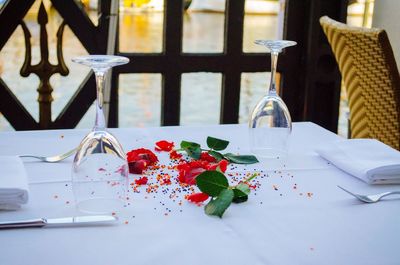 Wineglasses and flowers on dinning table