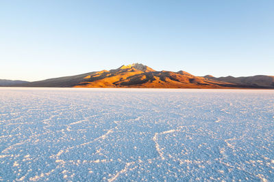 Scenic view of snowcapped mountains against clear blue sky