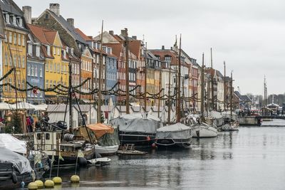 Boats in river in city