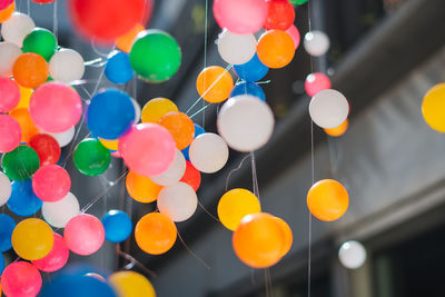 Low angle view of multi colored balloons