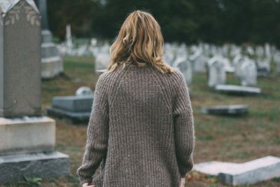 Rear view of woman at cemetery