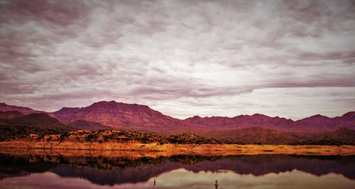 Scenic view of lake against cloudy sky