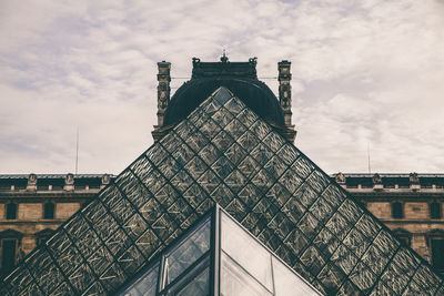 Low angle view of building against cloudy sky