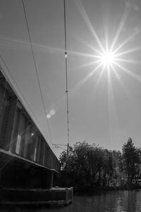 Low angle view of bridge over river against sky