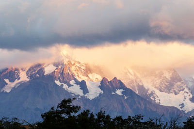 Scenic view of snowcapped mountains against sky during sunset