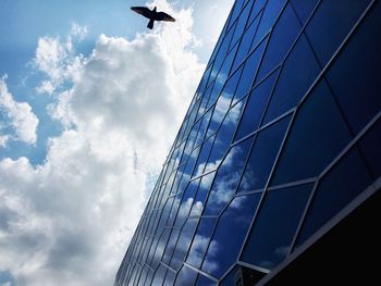 Low angle view of modern building against cloudy sky