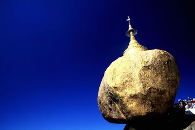 Low angle view of cross against clear blue sky