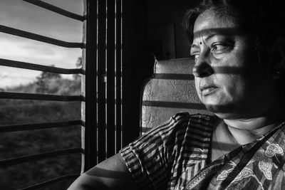 Woman looking through train window