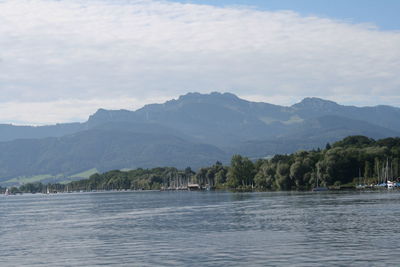 View of calm sea with mountain range in background