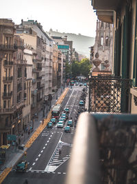 Traffic on road amidst buildings in city