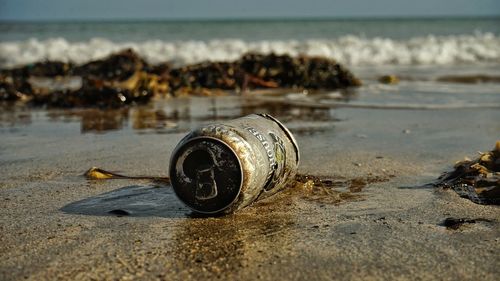 Close-up of abandoned sand on beach