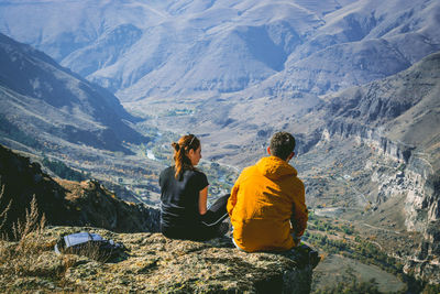 Rear view of people looking at mountains