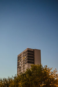 Low angle view of building against clear blue sky