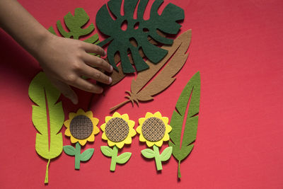 High angle view of woman holding red painting
