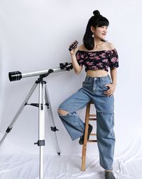 Young woman looking away over white background