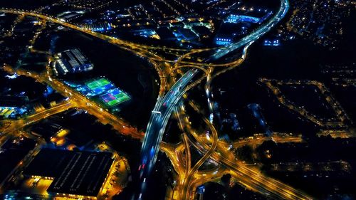 High angle view of illuminated city buildings at night