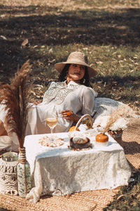 Full length portrait of man sitting on table