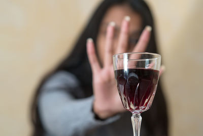 Close-up of woman holding beer glass