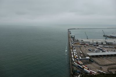 View of harbor against cloudy sky