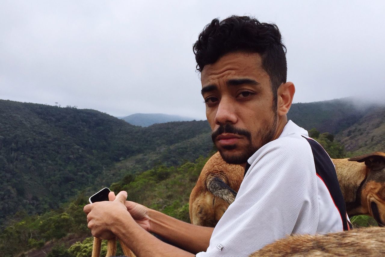 mountain, young men, mountain range, young adult, tourism, person, casual clothing, looking at camera, scenics, tranquil scene, tranquility, vacations, non-urban scene, beauty in nature, sky, physical geography, adventure