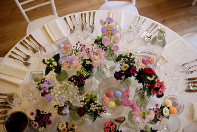 High angle view of flower vase and empty glass on dinning table