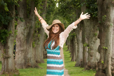 Portrait of woman by trees in park