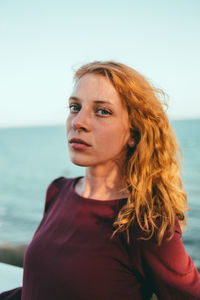 Portrait of woman against sea and sky