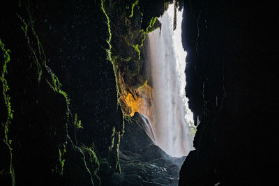 Scenic view of sea seen through cave