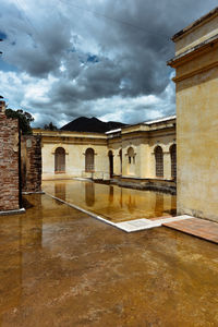 Low angle view of historic building against cloudy sky