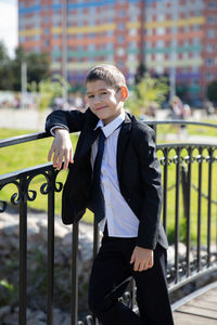 Portrait of boy smiling on railing