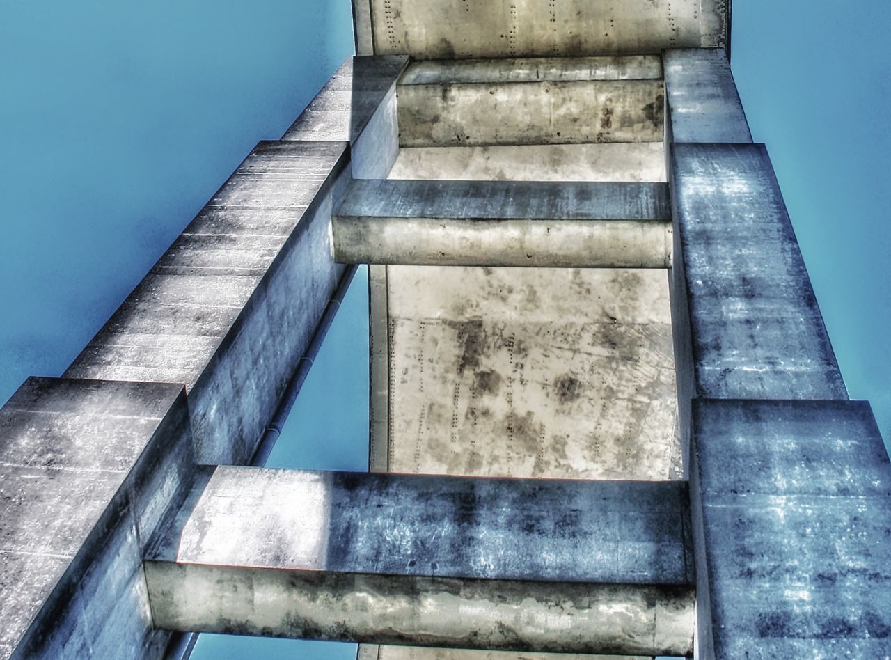 architecture, blue, built structure, no people, low angle view, staircase, day, sky, nature, water, building exterior, concrete, outdoors, old, connection, wall - building feature, metal, ladder, architectural column