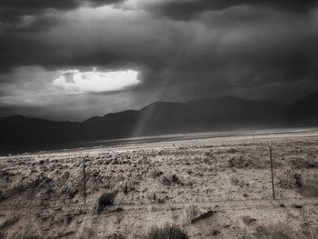 Scenic view of mountains against cloudy sky