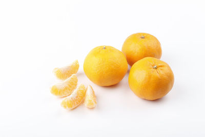 Close-up of oranges against white background