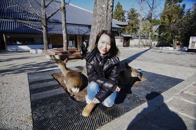 Portrait of young woman with deer