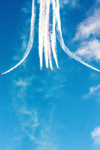 Low angle view of airplane flying against blue sky