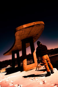 Rear view of man standing against sky