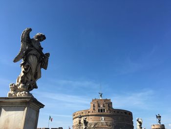 Low angle view of statue against cloudy sky