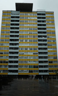Low angle view of yellow building against sky