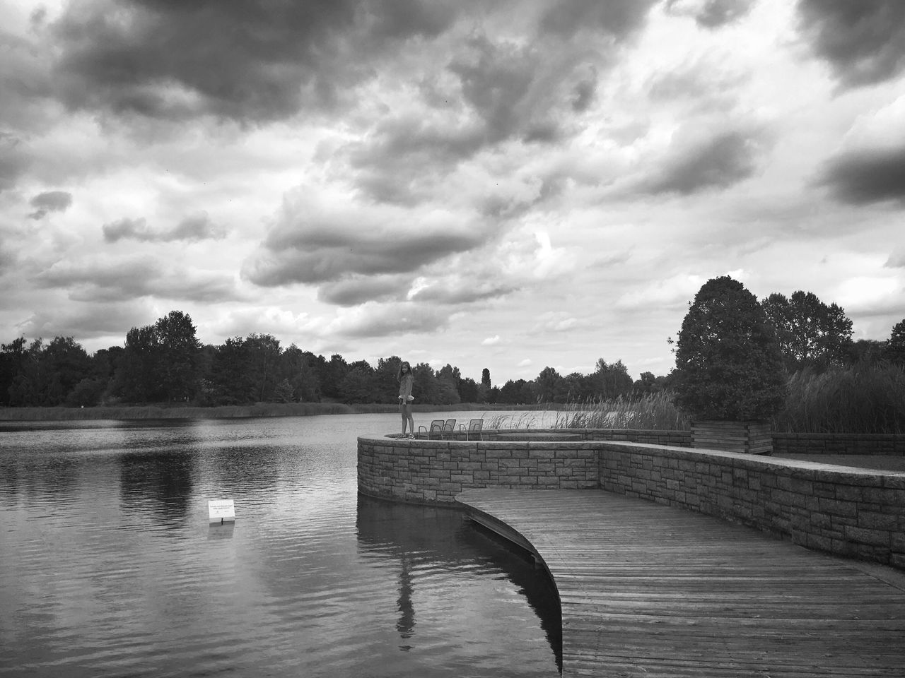 sky, water, cloud - sky, lake, tree, tranquility, tranquil scene, cloudy, river, cloud, scenics, nature, beauty in nature, overcast, rippled, day, outdoors, lakeshore, idyllic, no people, non-urban scene, calm, landscape, weather, growth, remote, non urban scene