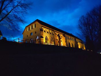 Low angle view of illuminated building against sky at night