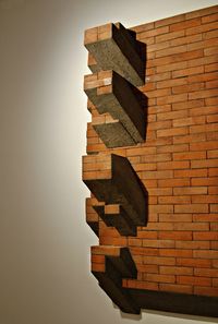 Stack of stone wall against building