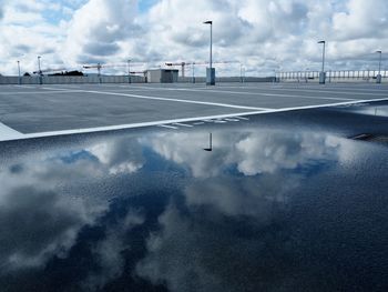 View of empty road against cloudy sky