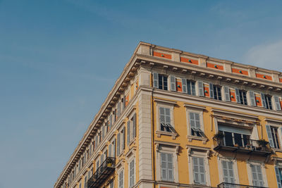 Low angle view of a residential building in nice, france, against the blue sky.