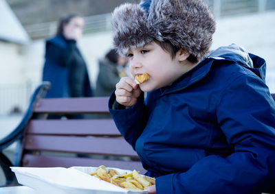 Full length of man eating food