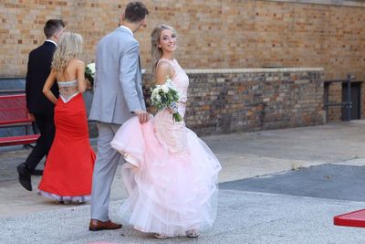 Portrait of smiling bride walking with bridegroom