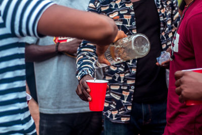 Midsection of man holding drink