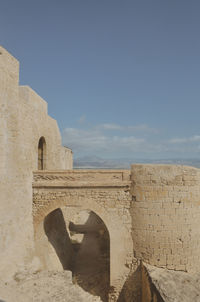 Low angle view of historical building against clear blue sky