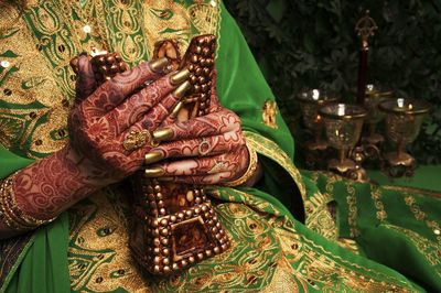 Midsection of bride holding decoration during wedding