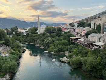 High angle view of townscape by river against sky